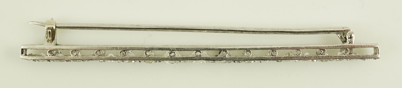 A 1920's platinum? and nineteen millegrain set graduated diamond bar brooch, 59mm, gross weight 4.6 grams. Condition - fair to good